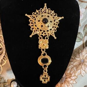 Elegant Gold and Black Star Brooch